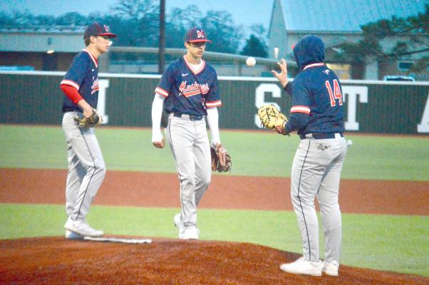 Cade Hathorn, Caden Miller and Cutter Smith gather around the mound at MHS during a Madisonville home game. CAMPBELL ATKINS