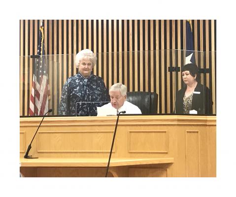 Nancy Page (left) and Veronica Landmann look on as Madison County Judge Tony Leago reads a proclamation recognizing Sept. 17-23 as Constitution Week in Madison County. PHOTO BY CAMPBELL ATKINS