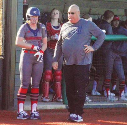 Madisonville head coach James Croley discusses strategy with Kyndall Creighton prior to an at-bat during a Lady Mustangs home game at MHS. (See News for more) CAMPBELL ATKINS