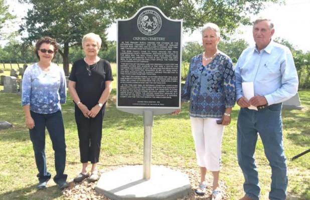 Oxford Cemetery Association members pose with the newly erected plaque recognizing its historical significance Saturday. PHOTO BY CAMPBELL ATKINS