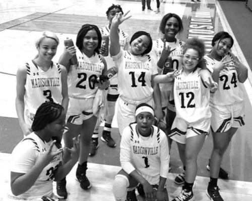 Members of the Madisonville women’s basketball team pose together at MHS Friday after defeating Connally, their second straight win in district play. COURTESY PHOTO