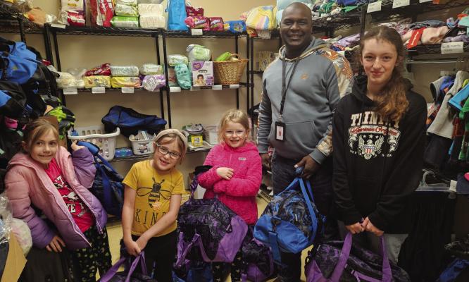 Madisonville Girl Scout Troop #9504 donated 18 duffle bags stuffed with dental hygiene items, combs/brushes, soap, deodorant, etc., activity books, journals, crayons, markers, blanket and stuffed animals to the Madison County CPS Rainbow Room. Pictured, left to right: Jayden, Malley, Cadence, CPS Caseworker Latariyon Tryon and Trinity. COURTESY PHOTO BY TIFFANY MCCLURE