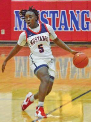 Ke’Myreul Wheaton handles the ball during a Lady Mustangs home game at MHS. CAMPBELL ATKINS