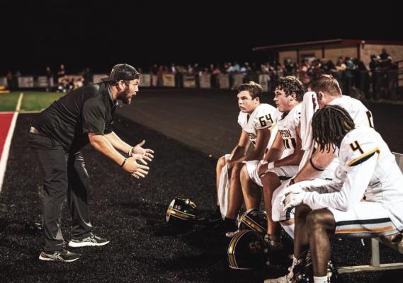 Austin Ashley on the sidelines coaching some of his offensive linemen. COURTESY PHOTO