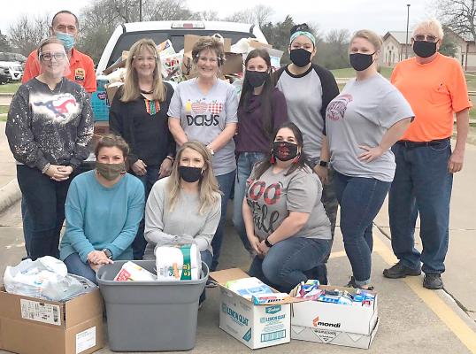 Son-Shine Center personnel Bobby Blecher (left) and Terry Clark pose with Madisonville Kindergarten teachers (top, from left) Lauren Todd, Susan Allen, Linda Vinson, Sara Villarreal, Jalisa Louis, Elizabeth Carter, (bottom, from left) Katie Hooks, Jessica Pasket and Chelsea Kolvig. COURTESY PHOTO