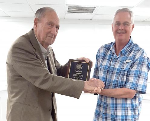 Mayor William Parten presents Mayor Pro Tem Russell Bailey with a plaque recognizing his years of services at his final city council meeting March 15. COURTESY PHOTO