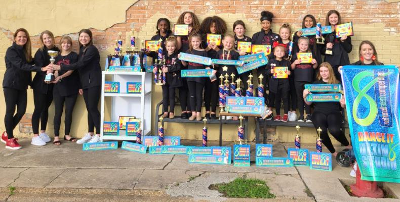 Carpe Diem Dance and Fitness personnel and dancers, who have garnered numerous awards and will compete in two National competitions this summer, pose outside the studio. COURTESY PHOTO