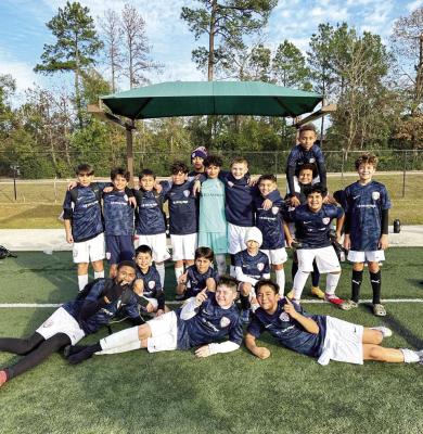 FC Mustangs Blue soccer players celebrate after going 1-0-1 in their first tournament of the year. Another win sends the team to the championship match after opening tournament action with a 3-3 draw and 1-0 victory. COURTESY PHOTO