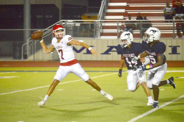 Xzavier Whaley (5) and Conner Swonke chase down Diboll quarterback Haydn Harris Friday. PHOTO BY CAMPBELL ATKINS