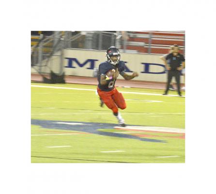Jeramiah Burns looks for running room against Liberty at MHS Friday.