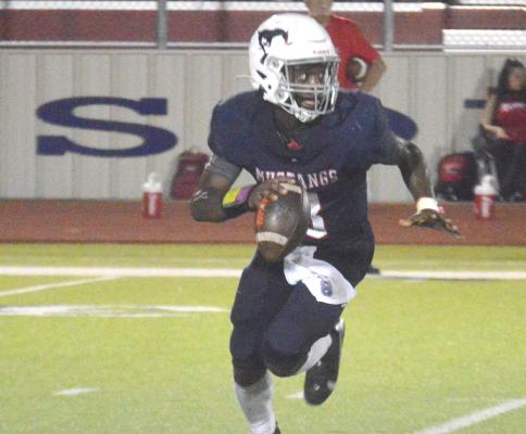 Jeramiah Burns looks for an open man at MHS Friday. CAMPBELL ATKINS