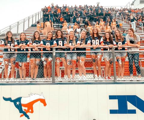 Members of the Madisonville volleyball team pose together at Friday’s football game after defeating Hudson in straight sets during their homecoming matchup. ALYSSA CLOPTON