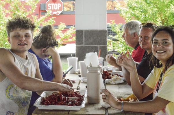 Festivalgoers enjoy a tasty crawfish feast during the annual Madisonville Mudbug Festival Saturday, April 13. The annual event celebrates Louisiana-style cuisine and culture, drawing visitors from across the region to indulge in the beloved crustacean and enjoy live music and entertainment. For more photos, see Page 11. METEOR PHOTO BY LYNDIE DUNN