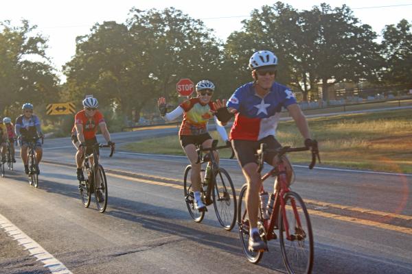 Cyclists coast past tree-lined fields under clear blue skies Saturday, Oct. 11, during the Tour de Madison. 