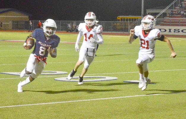Jeramiah Burns breaks loose on a run up the sidelines during Madisonville district loss to Rusk Friday at MHS. CAMPBELL ATKINS