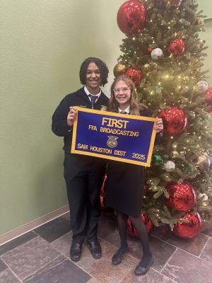 North Zulch FFA broadcasting team members display their first place banner after winning the Sam Houston District competition in Livingston on Friday, Nov. 14.