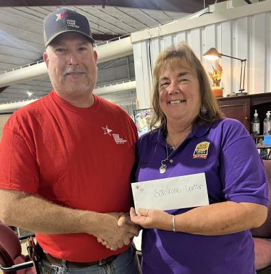 Madison County Farm Bureau Board President Kevin Counsil (left) presents a donation check to SonShine Center's Lisa Wamsley at the organization's facility. The Farm Bureau makes annual contributions to the center, which provides assistance to Madison County residents in need. COURTESY OF MADISON COUNTY FARM BUREAU
