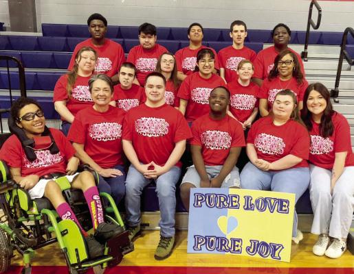 Madisonville students and staff from the Life Skills Class wear matching Mustang shirts ahead of Down Syndrome Awareness Week, March 16-20. This year’s theme is “Pure Love, Pure Joy.” Participants will show their support by wearing colorful socks for Crazy Sock Day, Wednesday, March 18. COURTESY PHOTO