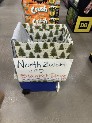 COURTESY PHOTO A donation box wrapped in Christmas paper sits inside the North Zulch Dollar General collecting blankets, socks and slippers for the North Zulch Volunteer Fire Department's senior safety program.