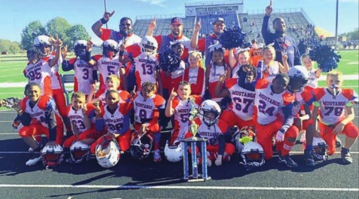 COURTESY PHOTO Madisonville’s Junior team poses together after winning the Division trophy Nov. 13.