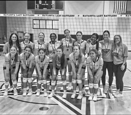 Lady Mustangs volleyball players celebrate after winning the Navasota Tournament championship on Saturday, Aug. 17 at Rattler Gym in Navasota. COURTESY PHOTO