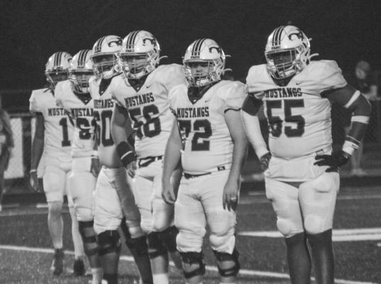 The Mustangs defense line during the last quarter of the game.