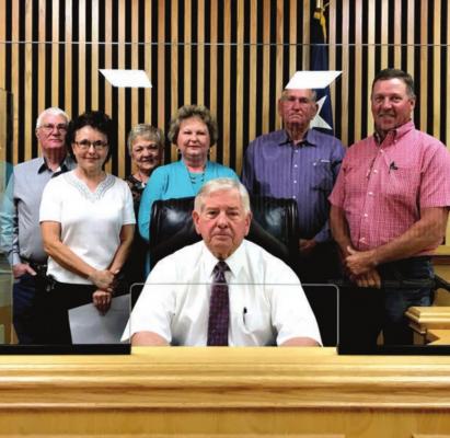 Oxford Cemetery Association members (standing, from left) Dan Madole, Jane Pryor, Angela Fannin, Glinda Mason and Lloyd Mason pose with Precinct 4 Commissioner David Pohorelsky and Madison County Judge Tony Leago (seated). PHOTO BY CAMPBELL ATKINS