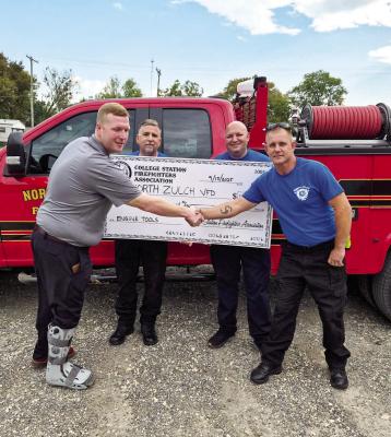 COURTESY PHOTO The North Zulch Volunteer Fire Department received a donation from the College Station Professional Firefighters Association, International Association of Fire Fighters Local 4511, in the amount of $1,000. The donation is to help purchase hand tools for the department’s apparatus. Pictured, left to right: Austin Hoggard, NZVFD Assistant Chief Pat Coveney, Stuart Dial, and NZVFD Chief Chuck Wiedecker.