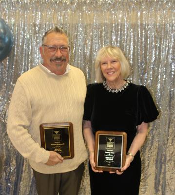 Michael Emanuelli (left) and Tammy Hoke are honored with Madison County Chamber of Commerce plaques Friday, Feb. 7, at the annual Denim &amp; Diamonds banquet. Emanuelli received the Man of the Year award for his work at the Woodbine Inn and Restaurant, while Hoke, president of Prosperity Bank in Madison County, was named Woman of the Year.