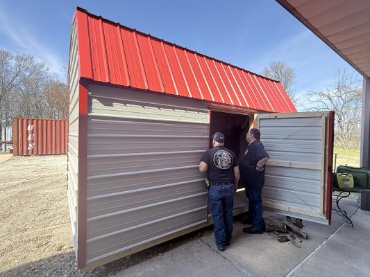 METEOR PHOTO BY RICHARD SIRMAN Assistant Fire Chief Lewis Mitchell (left) and EMS Captain Keith Hahn inspect the new storage building at the Madisonville Fire Rescue station Monday, Feb. 9.