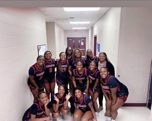 The Madisonville High School varsity girls basketball team celebrates after clinching the District 17-4A championship Tuesday, Feb. 10, at Bullard. COURTESY PHOTO