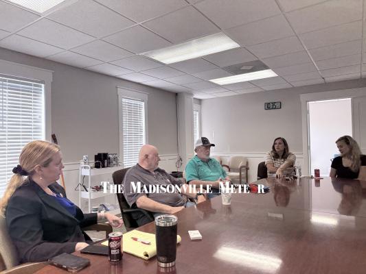 Madisonville City Manager Kelcey Young, left, listens as community members share ideas for the downtown square during her first Coffee with the City Manager event Feb. 27 at City Hall.