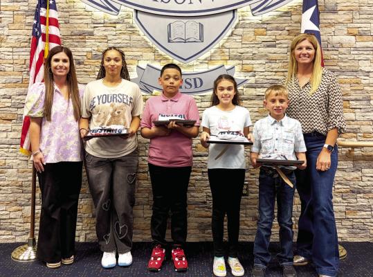 Madisonville Consolidated Independent School District board members Randi Pipes (left) and Quincy Allen (right) stand with May Students of the Month Char’Lecia Holland (high school), Alejandro Cisneros-Delgado (junior high), Molly Gaskins (intermediate) and Jozey Rahmn (elementary). COURTESY PHOTOS