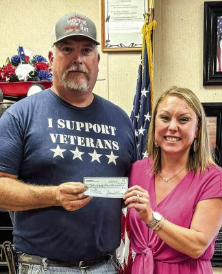 WoodmenLife – Madisonville, TX Chapter 4647 donated to the local Veterans Service Center for the purchase of flags for local veterans. Be on the lookout for more information on a Veterans Day celebration to be held November 9. Kevin Counsil presents the $500 donation check to Erica Greene, Veterans Service Officer. COURTESY PHOTO