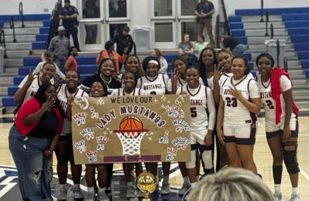 The Madisonville Lady Mustangs basketball team poses with the regional semifinal trophy after beating Freeman 40-20 on Monday, Feb. 23. COURTESY PHOTO