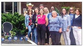 Members of Scotty’s House, local law enforcement, and members of the community, gather in front of the Madison County Courthouse after planting 18 pin-wheels.