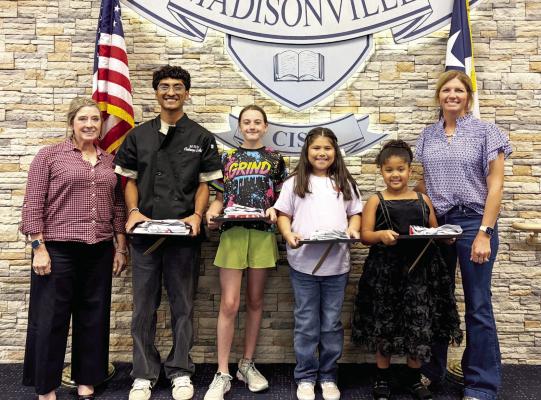 MCISD Students of the Month for March hold their awards at the district board room. Zingara Manning (far left) and Quincy Allen (far right) stand with Alexander Sanchez, Avery Conway, Penelope Maldonado and Hilena Mayes. Sanchez represents the high school, Conway the junior high, Maldonado the intermediate campus and Mayes the elementary. COURTESY PHOTOS