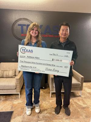 PHOTOS COURTESY OF TEXAS INTERNAL PIPE COATING Addison Allen holds a $5,999 check from Texas Internal Pipe Coating President Victor Liang for her Madisonville 4-H project.