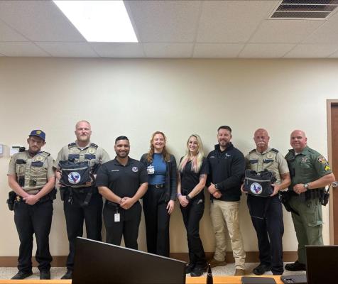Members of the Madison County Sheriff's Office pose with representatives from the Brazos Valley Regional Advisory Council and CHI St. Joseph Health Emergency Medical Services after receiving Stop the Bleed kits Thursday, March 26. The kits contain tourniquets, gauze, bandages, gloves and trauma shears for deputies to carry in the field.  