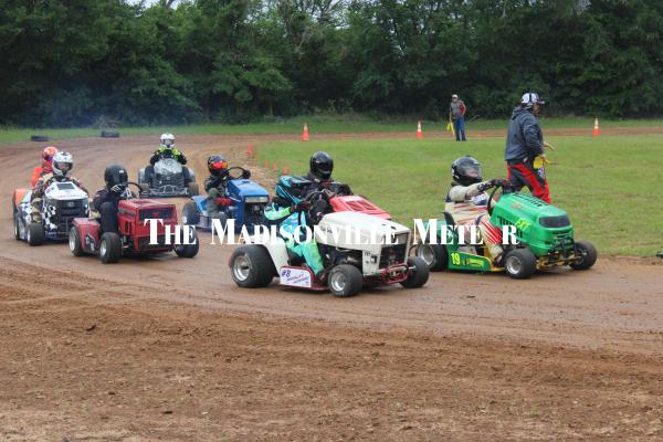 Lawn mower racers from the Lone Star Mower Racing Association tear around a dirt track at the Mudbug and Music Festival on Saturday, April 18 at Lake Madison Park in Madisonville.