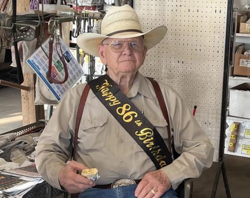 COURTESY PHOTO Bobby Wise sits at Madisonville Feed Center during his 86th birthday celebration. Wise opened the store 55 years ago with his college friend and business partner Jimmy Wells.