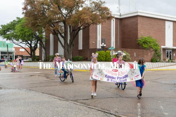 Children ride through downtown Madisonville April 4 on decorated bikes and bring in the 45th annual Miss Rita's Easter Parade and Egg Hunt banner. The local tradition honors the late Rita Reynolds Slaughter-Davis, who started the parade in the early 1980s for Madison County youth. 