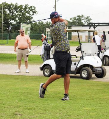 A golfer takes his shot Saturday, June 7, during the second Fire in the Hole Golf Tournament at Fannin Oaks Golf Course and Event Center. The event drew 18 teams who competed to raise money for the Madisonville Volunteer Fire Department. METEOR PHOTO BY RICHARD SIRMAN