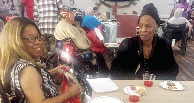 PHOTOS COURTESY OF AVIR Residents at AVIR at Madisonville enjoy a Christmas Eve party on Wednesday, Dec. 24, with some of the gifts donated by Living Truth Church and more.