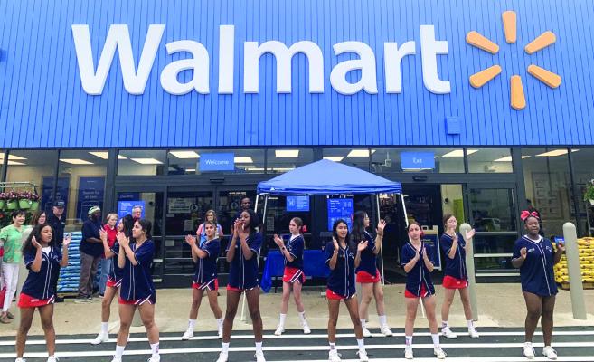 Madisonville cheer squad at the Walmart doing a cheer for the community and the store.