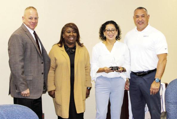 Brazos Valley Council of Governments officials present the Impact Award to Elena Fortaneli (second from right) of Monterey Mushrooms. Also pictured are Roger Sheridan (left), interim executive director of BVCOG; Vonda Morrison, Workforce Board program manager; and Robert Orzabal, Workforce Board chair. COURTESY PHOTO