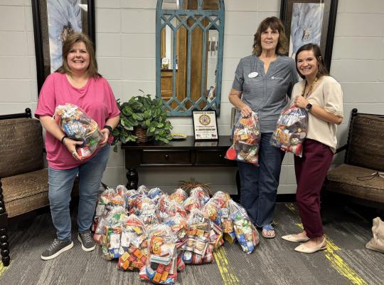 COURTESY PHOTO WoodmenLife Chapter 4647 members deliver backpacks filled with food to North Zulch Independent School District. Pictured are Dee Barnes (left), Chapter 4647 secretary; Lois Milstead, sales representative; and Amanda Austin, North Zulch ISD.