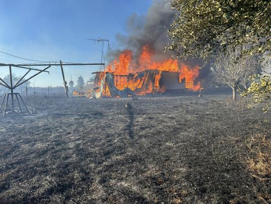 A vacant home is engulfed in flames Oct. 20 as a grass fire spreads across Clark Road in Madison County. Two homes and several sheds were destroyed in the 15-acre blaze. PHOTO COURTESY NORTH ZULCH VFD