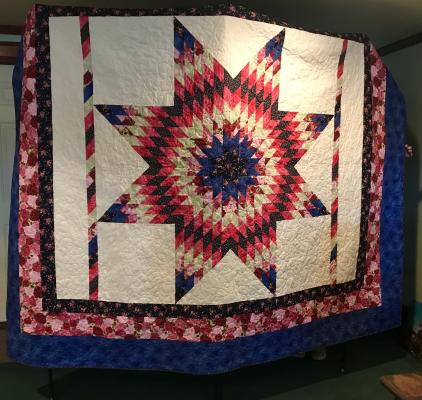 PHOTO COURTESY OF MADISON COUNTY MUSEUM A star-pattern quilt hand-stitched by Georgia Taylor hangs on display at the Madison County Museum, where it anchors a raffle running through Oct. 21. The museum, open 10 a.m. to 2 p.m. Wednesday through Saturday at 201 N. Madison St., is selling raffle tickets for the quilt — $1 each or six for $5. Tickets are available at the museum and from others helping with the sale.