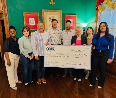 Members of the Madisonville Area Revitalization Initiative and Stover & Crouch Insurance gather at the Woodbine Inn and Restaurant as the insurance agency presents a $1,500 donation to the group June 19.